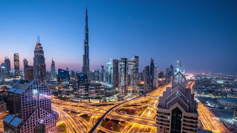 Time lapse Aerial view and top view of traffic on city streets in Dubai.Expressway with car lots. Beautiful roundabout road in the city center.
