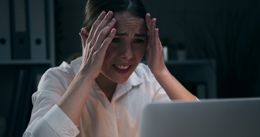 Businesswoman regretting her wrongdoing at night office | Shutterstock HD Video #1054094441