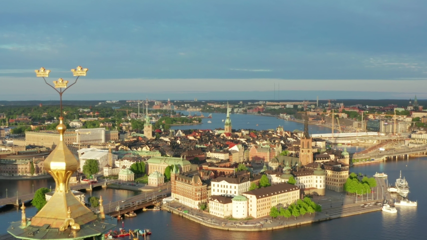 Drone shot Stockholm City Hall Old Town Gamla Stan aerial view. Summer evening in on of the most beautiful cities in the world. Cityhall from above in Sweden Royalty-Free Stock Footage #1054095221