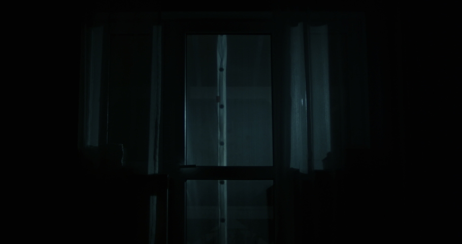Thief is Looking inside the House Through the Windows with Flashlight Opening the Back Door and Entering the Property at Night Shot on Red Epic Royalty-Free Stock Footage #1054102478