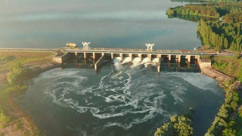 Aerial panoramic view of Hydroelectric Dam on river at sunset