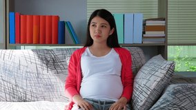 Pregnant young asian woman do not want to eat healthy food or vegetable salad, Pregnants Mother give salad to her. Headstrong girl get bad smell it and give back to her mom Pregnant girl bored food