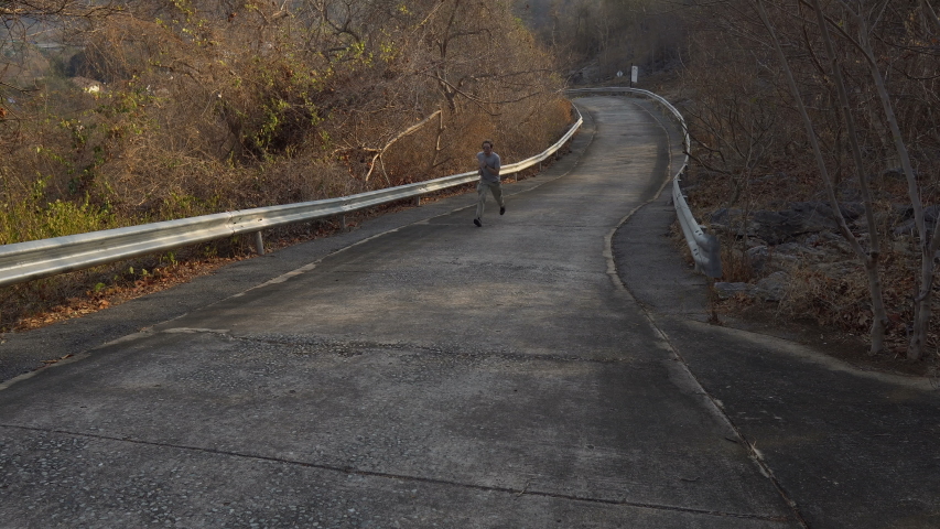 Young Man Sprinting Uphill During Exercise Run