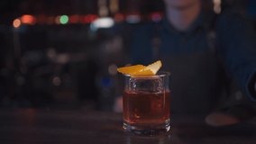 bartender preparing traditional old fashioned cocktail with whiskey and orange - Powered by Shutterstock - Get 15% off with code: PIKWIZARD15
