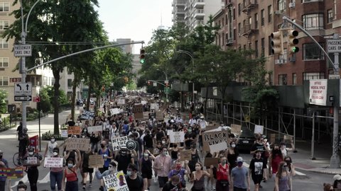 NEW YORK - JUNE 10, 2020: peaceful Black Lives Matter protestors marching up 5th Avenue with signs after rally in Washington Square Park, in New York City, NYC.