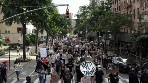 NEW YORK - JUNE 10, 2020: peaceful protestors with signs for Black Lives Matter, marching up 5th Avenue after historic rally in Washington Square Park, New York City, NYC.