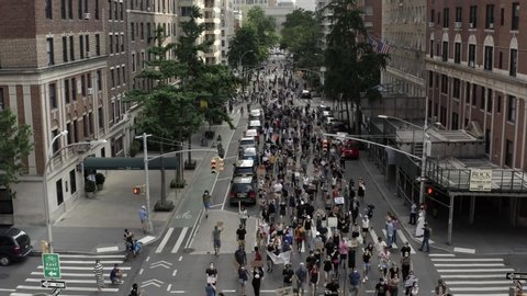 NEW YORK - JUNE 10, 2020: thousands march in Black Lives Matter protest of George Floyd and all African Americans who fall victim to police brutality, demonstration on Lower 5th Avenue in NYC.