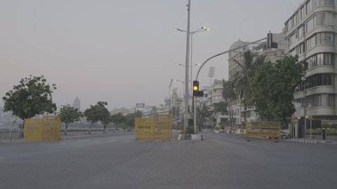 A wide shot of a empty city/ urban street/ road at Marine lines driver Nariman Point during lockdown amid Coronavirus or COVID 19 pandemic or epidemic, Mumbai, India (May 2020)