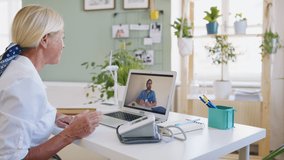 Senior woman with laptop at home , consulting doctor and video call concept.
