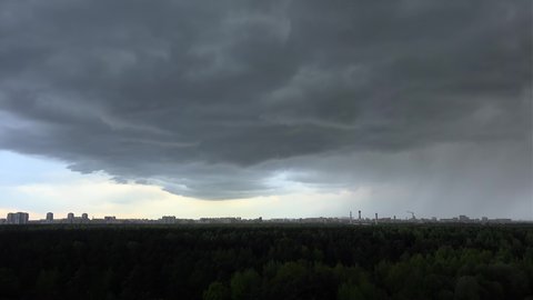 Stormy front over the city skyline. Timelapse.