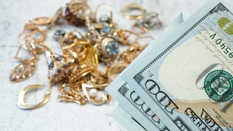 jewelry scrap of gold and silver and money, pawnshop concept 