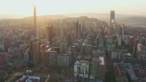 AFRICA,SOUTH AFRICA,CIRCA 2020.Aerial view of smog and pollution hanging over the Johannesburg City Centre at sunrise