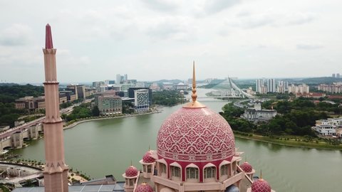 Putrajaya, Malaysia. Aerial top view of the Putra Mosque, surrounded by Putrajaya Lake and tropical trees.