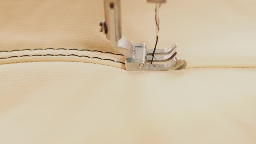 Closeup of sewing machine working part with leather. Cnc sewing machine Royalty-Free Stock Footage #1054147172