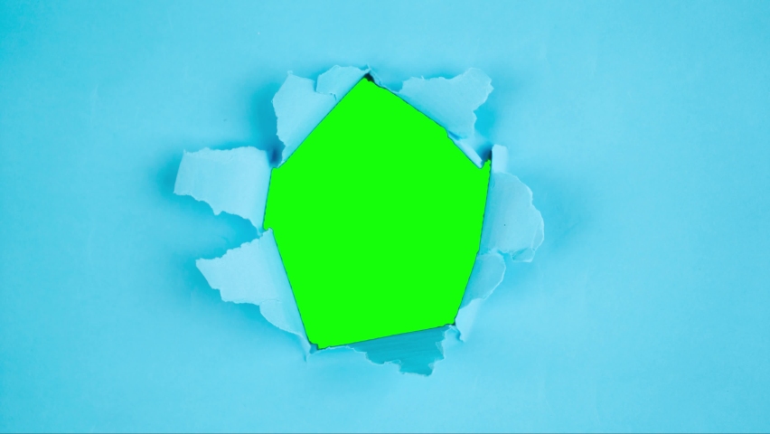Stop motion of green screen background appearing through torn hole on variety color papers. Shot in 4k resolution