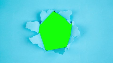 Stop motion of green screen background appearing through torn hole on variety color papers. Shot in 4k resolution