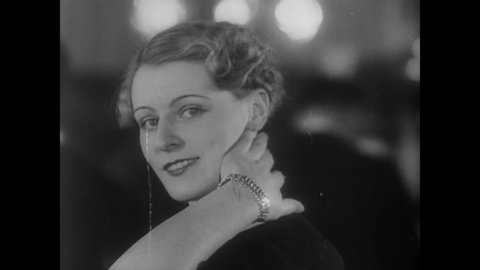 CIRCA 1934 - The new French style of haircuts for women shows off the ears (narrated in 1959).