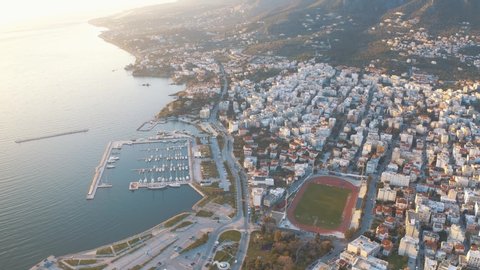 Buildings And Houses In Mytilene City In Lesvos Island, Greece Surrounded By The Blue Sea At Sunset. - aerial drone shot