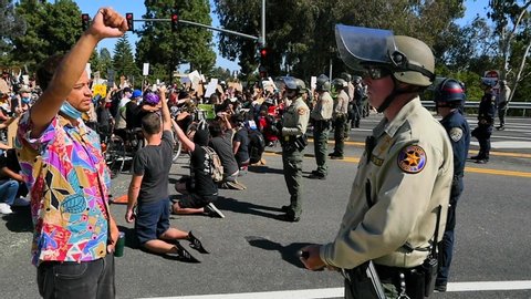 VENTURA, CALIFORNIA - CIRCA 2020 - Slo mo protesters chanting and standing off with police and National Guard during a Black Lives Matter march.