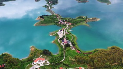 Aerial reverse above Ramsko turquoise lake, Bosnia and Herzegovina