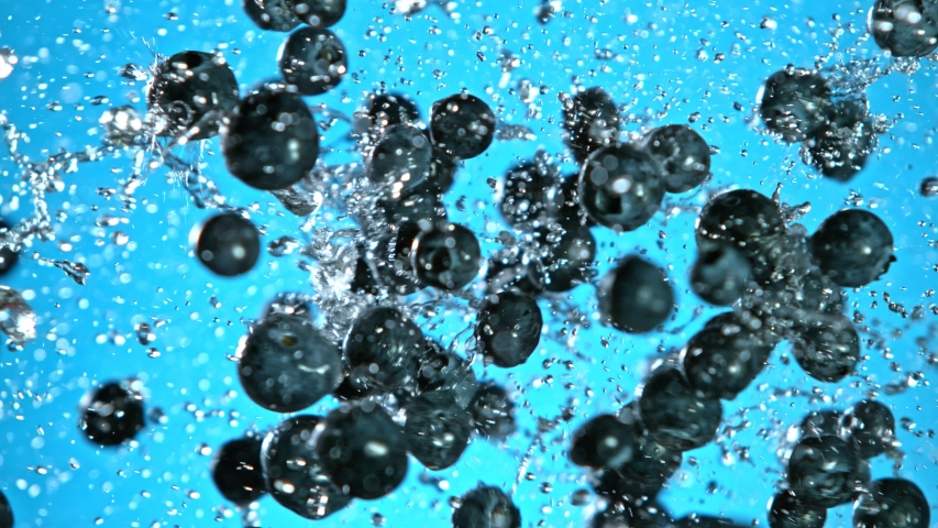 Super Slow Motion Shot of Flying and Splashing Fresh Blueberries on Blue Gradient Background at 1000fps. | Shutterstock HD Video #1054176836