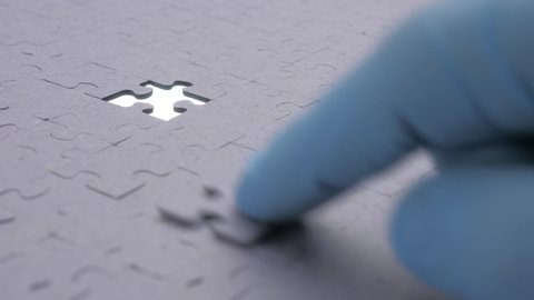 Missing jigsaw puzzle piece, business concept for completing the final puzzle piece. Completing grey puzzle with missing piece. Drag last piece of puzzle with a finger to its right place