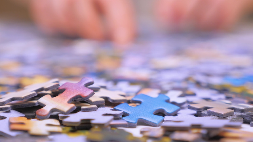 Finding the solution concept. Hand matching jigsaw halves. Leisure activity. Achieving the goal step by step. Engaging in successful work finding business solution, corporate unity Royalty-Free Stock Footage #1054178681