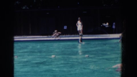 FRENCH LICK INDIANA-1958: People Enjoying Sunny Day In And By The Pool Working At The Street