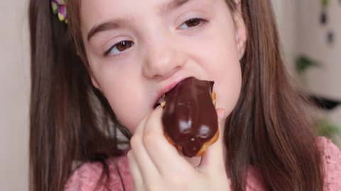 eight years old girl eats eclair