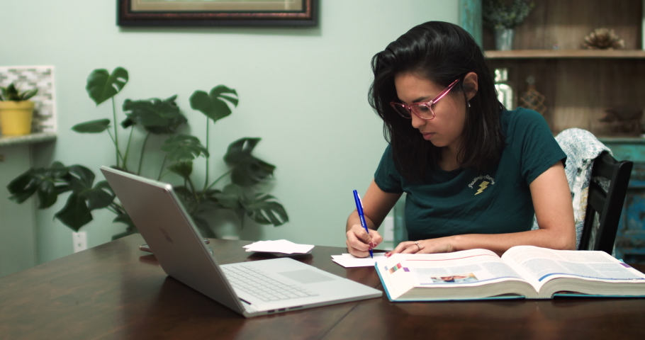 Young Hispanic Student attends online class at home Royalty-Free Stock Footage #1054212350