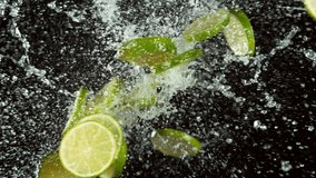 Super slow motion of lime pieces collision with water splashes, black background. Filmed on high speed cinema camera, 1000 fps. - Powered by Shutterstock - Get 15% off with code: PIKWIZARD15