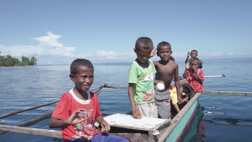 Raja Ampat Islands, West Papua, Indonesia - CIRCA 2020: Papuan People Papuans Melanesians Happy Cheerful Children on The Boat