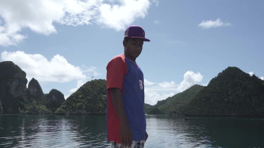 Raja Ampat Islands, West Papua, Indonesia - CIRCA 2020: Papuan People Papuans Melanesians Man Guiding The Boat in Wayag