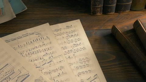 Hand-Written Sheets Of Music On The Table