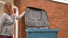 Girl closing lid to trash can slow motion - Powered by Shutterstock - Get 15% off with code: PIKWIZARD15