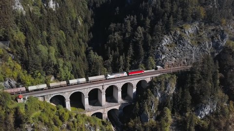 Aerial view of freight train rides on Krauselklause Viaduct on historical Semmering mountain railway (Semmeringbahn), Lower Austria.