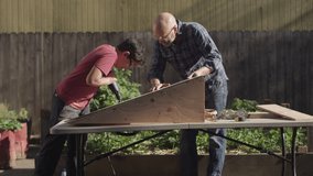 A father and his teenage son build a wooden ramp in the backyard - Powered by Shutterstock - Get 15% off with code: PIKWIZARD15