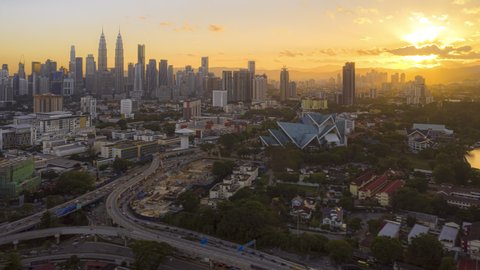 Malaysia Time lapse : Aerial sunrise city during dawn overlooking Kuala Lumpur city skyline and the Kuala Lumpur General Hospital with busy roundabout and streets. Prores UHD