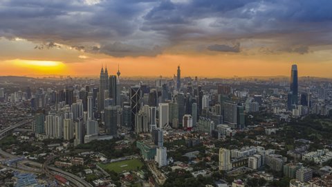 Kuala Lumpur Time Lapse: Sunset of cityscape during a golden sunset overlooking an elevated highway in Kuala Lumpur city. Malaysia. Hyperlapse.  Prores Full HD