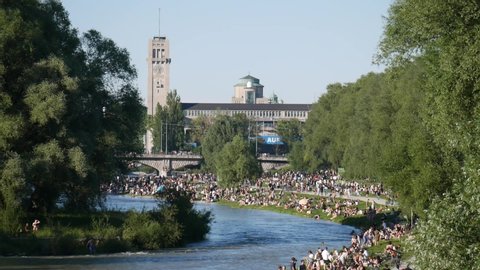 Munich, Germany - June 13th 2020: people relaxing on crowded Isar riverbank during corona lockdown