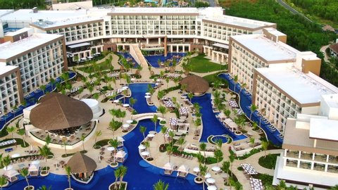 Pool area and bars in a tropical tourist resort, luxury hotel in Caribbean, aerial view of luxury hotel with exotic poolside
