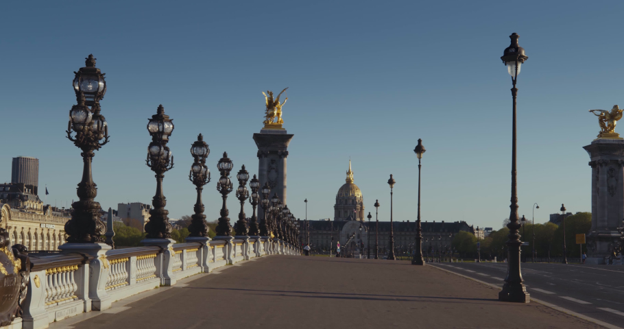 Empty street in Paris on the Alexandre 3 bridge in front of the hotel des invalides with blue sky Royalty-Free Stock Footage #1054257563