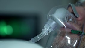 Male Patient Breathing Oxygen Support In Hospital, Next To Heart Rate Machine. - Powered by Shutterstock - Get 15% off with code: PIKWIZARD15