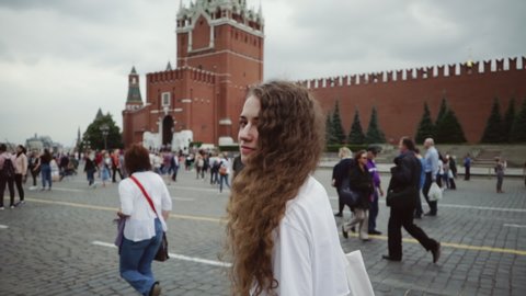 young caucasian girl tourist relaxing and walking around Moscow city and Kremlin, red square, Russia