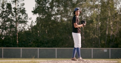 Perfect fastball pitch. Baseball pitcher throws hard pitch. Heat down the plate from a young pitcher. Shot in 4k.