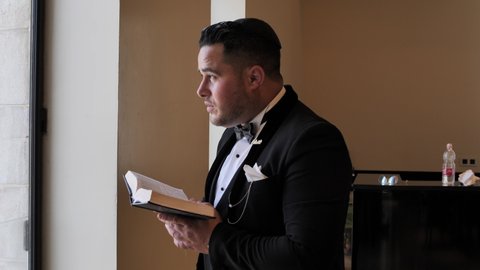 Jewish man in elegant outfit rise his eyes to God, praying, reading Holy Scripture