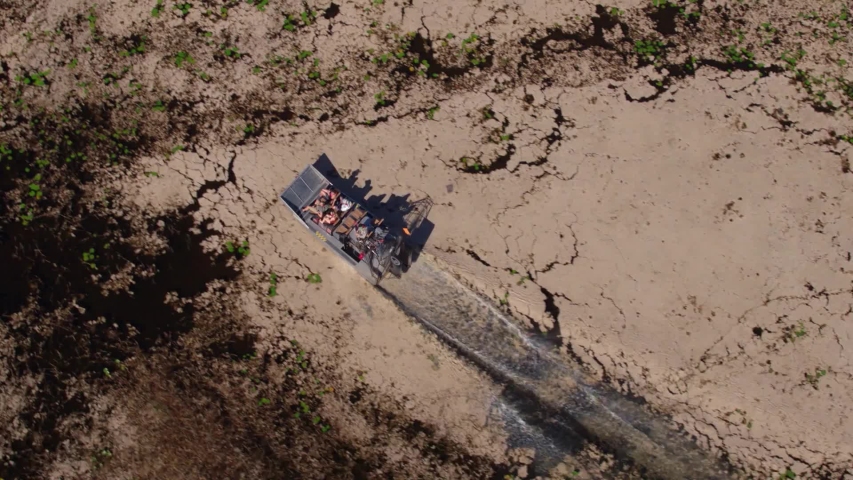 overhead aerial of airboat in swamp everglades slow motion