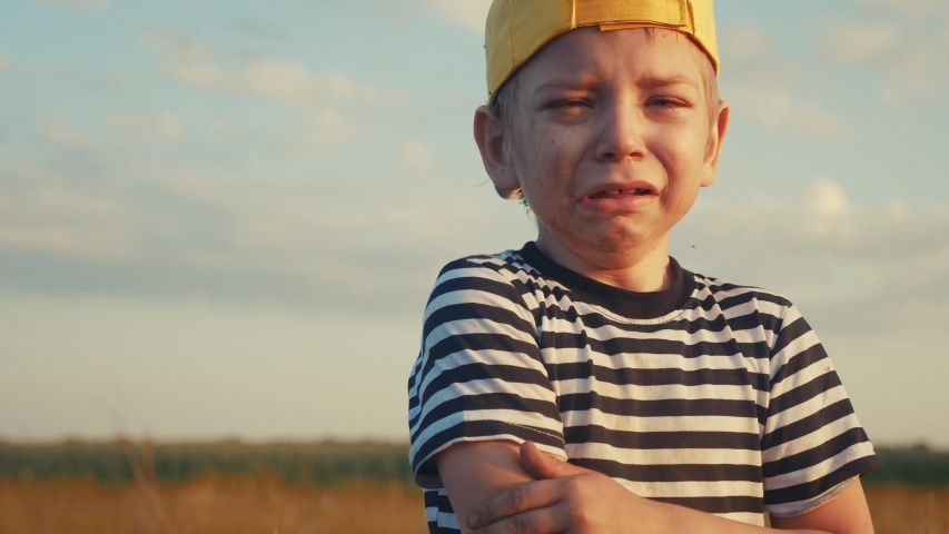 Boy kid crying flowing tears a screaming dirty face. child son scream disappointed cranky. domestic violence concept. kid close-up toddler roared all in tears lifestyle | Shutterstock HD Video #1054277375