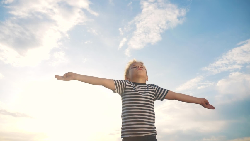 boy pray. pulls hands against a blue sky. child concept faith religion and happy family. kid son pray hands to the side against the blue sky jew kid praying to god. worship and gratitude religion Royalty-Free Stock Footage #1054277381