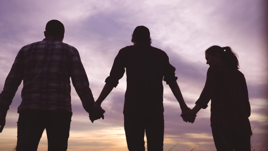 Teamwork. team community hold hands together silhouette at sunset unity. group of people hands. teamwork workers carry out one mission go to the goal . business team in the company working partnership | Shutterstock HD Video #1054277399